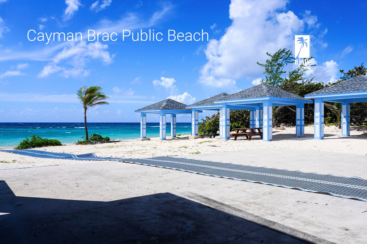 The scenic Cayman Brac Public Beach with gazebos, offering direct access to the clear Caribbean Sea for residents and visitors.